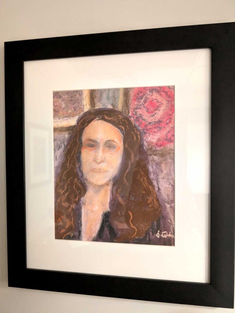 A framed portrait painting of a woman with long brown hair, featuring an abstract background with grey and red hues.