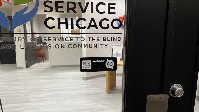 Glass door with "Service Chicago" text and a WayAround tag. Inside, an office room is visible with furniture and a reception desk.